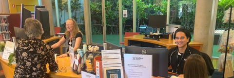 Image of Council staff talking to customers at the Cooroy Library
