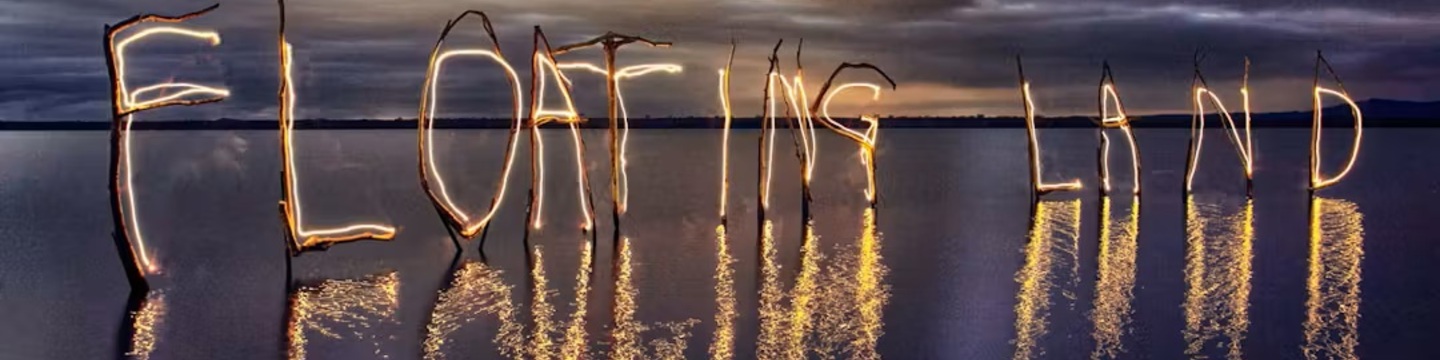 The words "Floating Land" is lit up on the Foreshore at Boreen Point