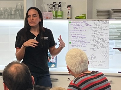 Image of a woman presenting information to a community group