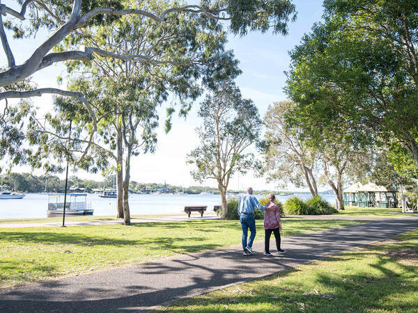 Male and female walk along the Noosaville Foreshore pathway